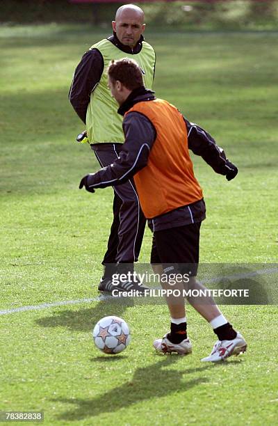 Roma's forward and captain Francesco Totti practices in front of his trainer Luciano Spalletti during a training session, 11 December 2007, on the...