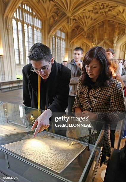 Visitors examine the 1217 issue of the 'Magna Carta,' which was sent to Gloucestershire, at the Divinity School of the Bodleian Library, in Oxford,...