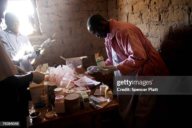 Pharmacist distributes medication at a rural health clinic run by Doctors Without Borders December 11, 2007 in Sikikede in the northern Central...