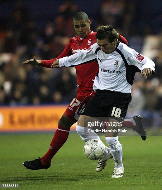 Darren Currie of Luton contests with Lewis McGugan of Nottingham during the FA Cup Sponsored by e.on Second Round Replay match between Luton Town and...