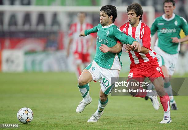 Diego of Bremen and Konstantinos Mendrinos of Piraeus fight for the ball during the UEFA Champions League Group C match between Olympiakos and Werder...