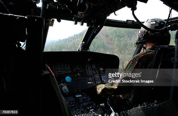 co-pilot aboard a uh-60 black hawk helicopter. - national guard stock pictures, royalty-free photos & images