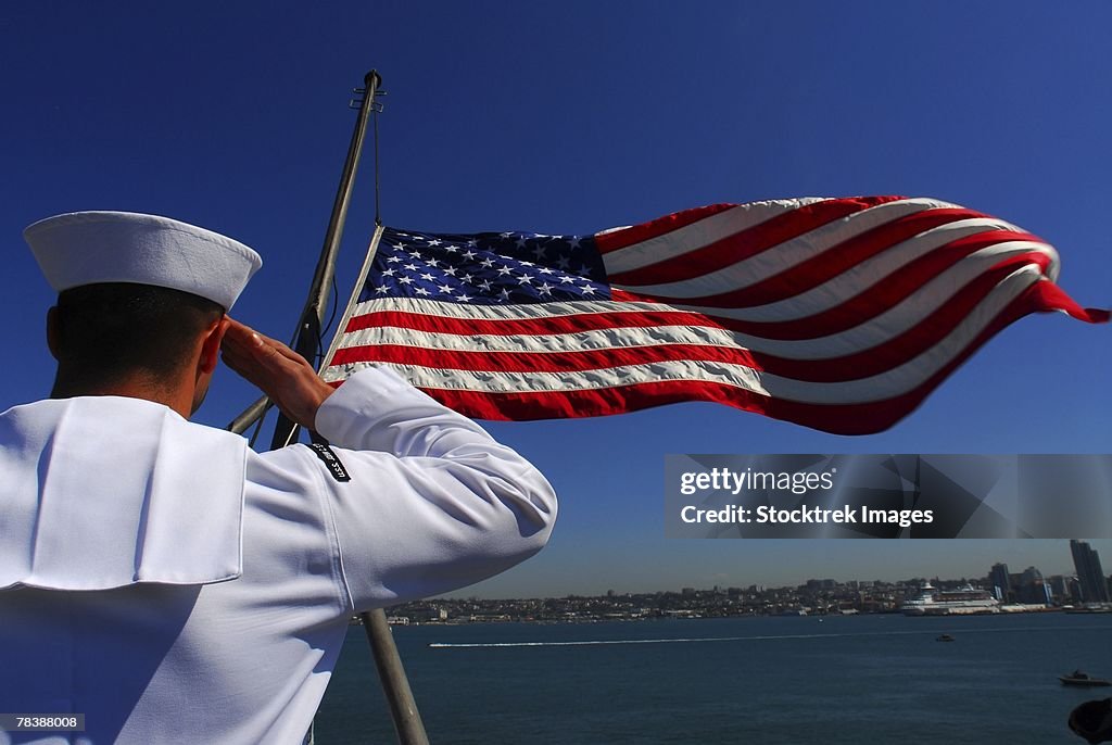 Airman salutes the American flag.