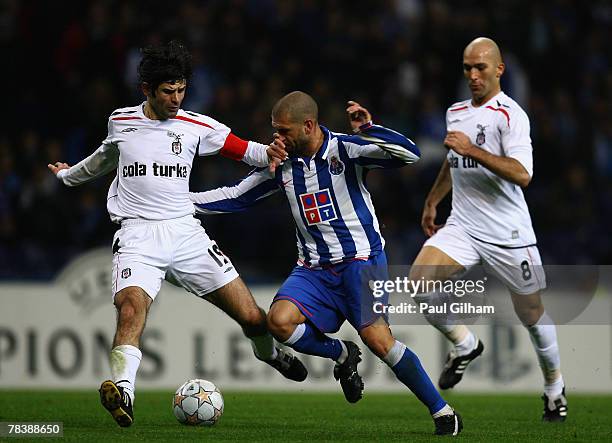 Lisandro Lopez of Porto battles for the ball with Ibrahim Uzulmez and Baki Mercimek of Besiktas during the UEFA Champions League Group A match...