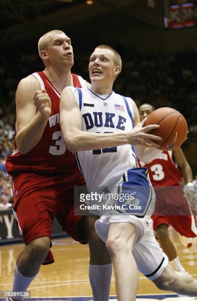 Kye Singler of the Duke Blue Devils drives to the basket against Greg Stiemsma of the Wisconsin Badgers at Cameron Indoor Stadium on November 27,...