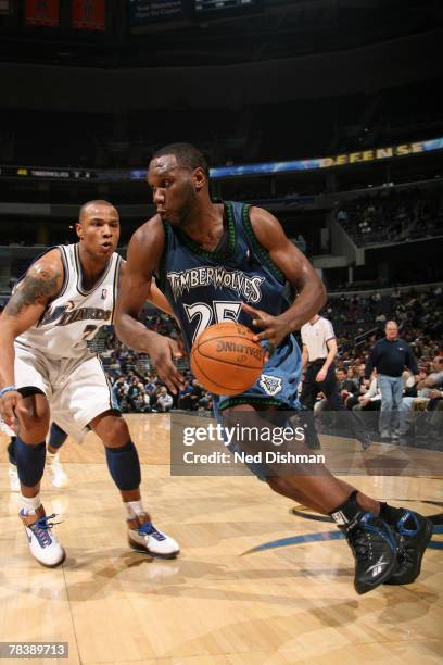 Al Jefferson of the Minnesota Timberwolves dribbles against Caron Butler of the Washington Wizards at the Verizon Center on December 11, 2007 in...