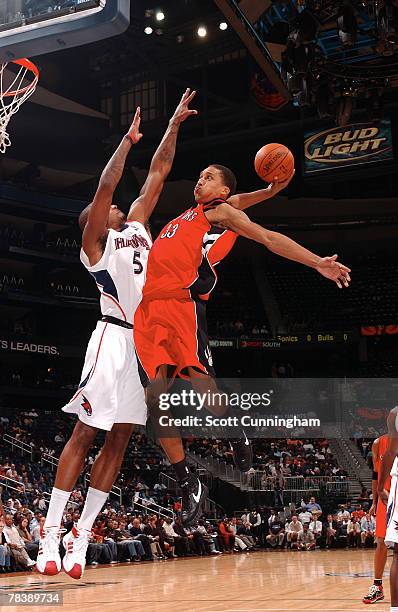 Jamario Moon of the Toronto Raptors winds up for a dunk against Josh Smith of the Atlanta Hawks at Philips Arena on December 11, 2007 in Atlanta,...