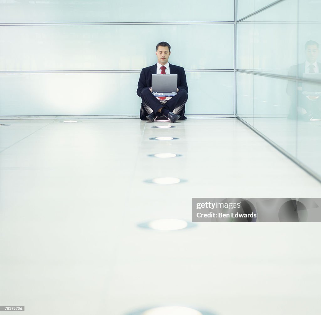 Isolated businessman working on laptop