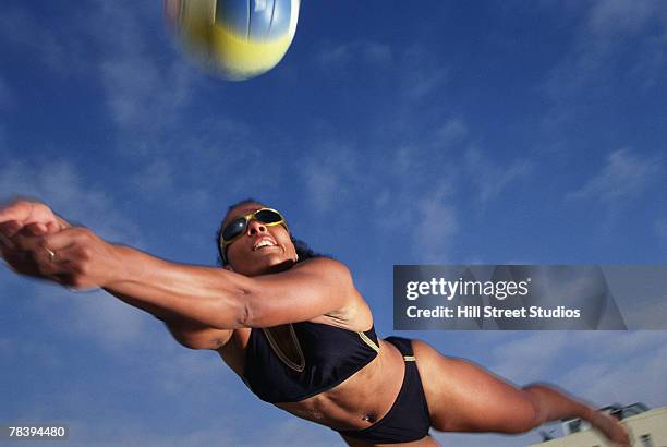 volleyball player diving for the ball - womens beach volleyball foto e immagini stock