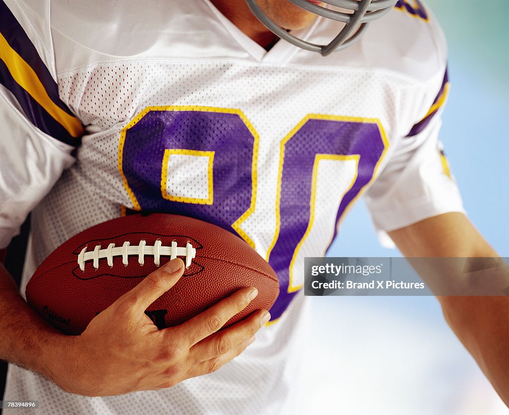 Football player carrying football