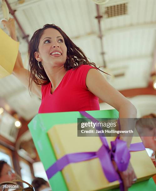 woman with gift boxes on bus - bus wrap stockfoto's en -beelden