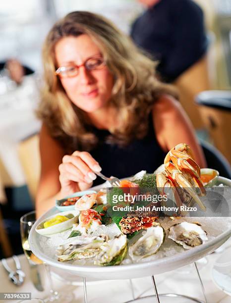 woman eating seafood - seafood platter bildbanksfoton och bilder