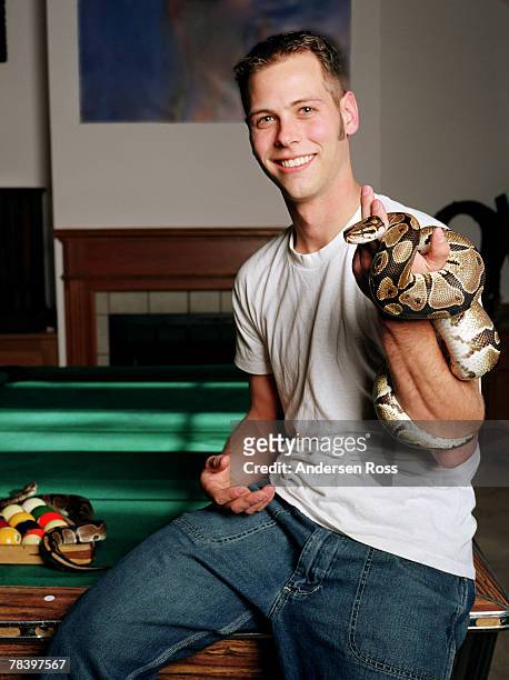 man holding snake - snake in pool stockfoto's en -beelden