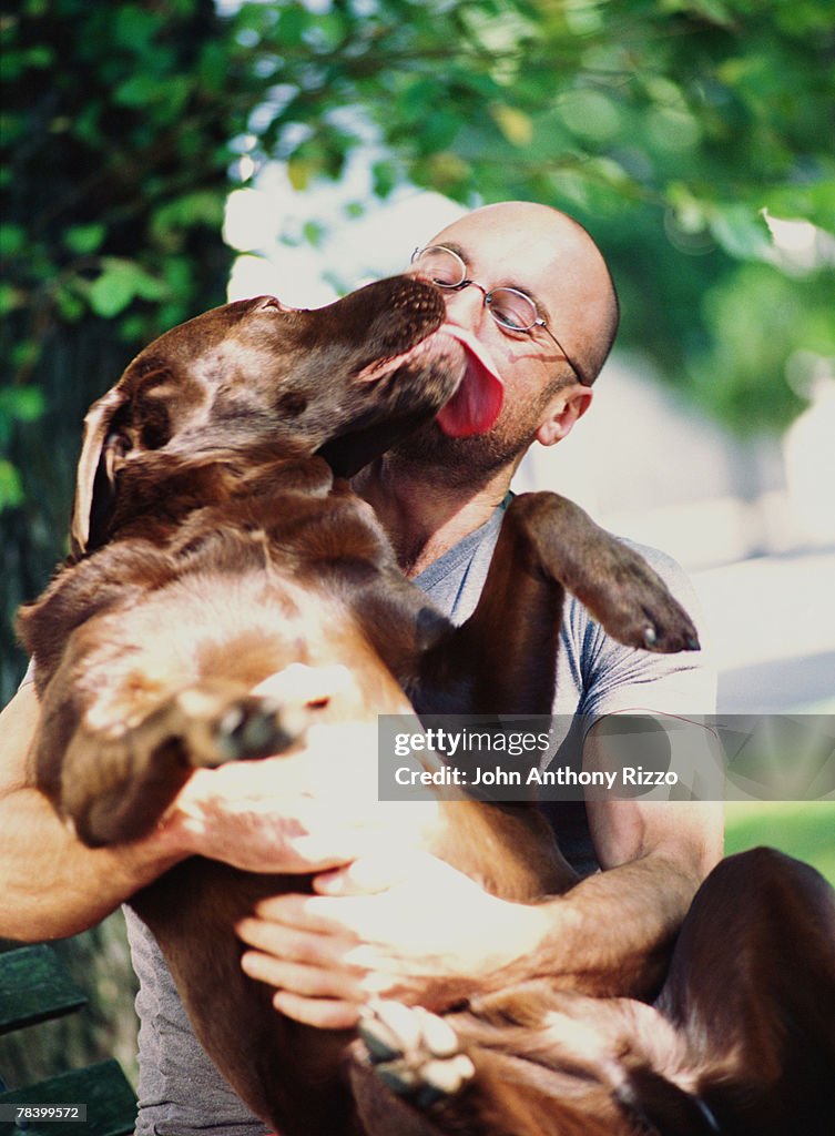 Man hugging pet dog