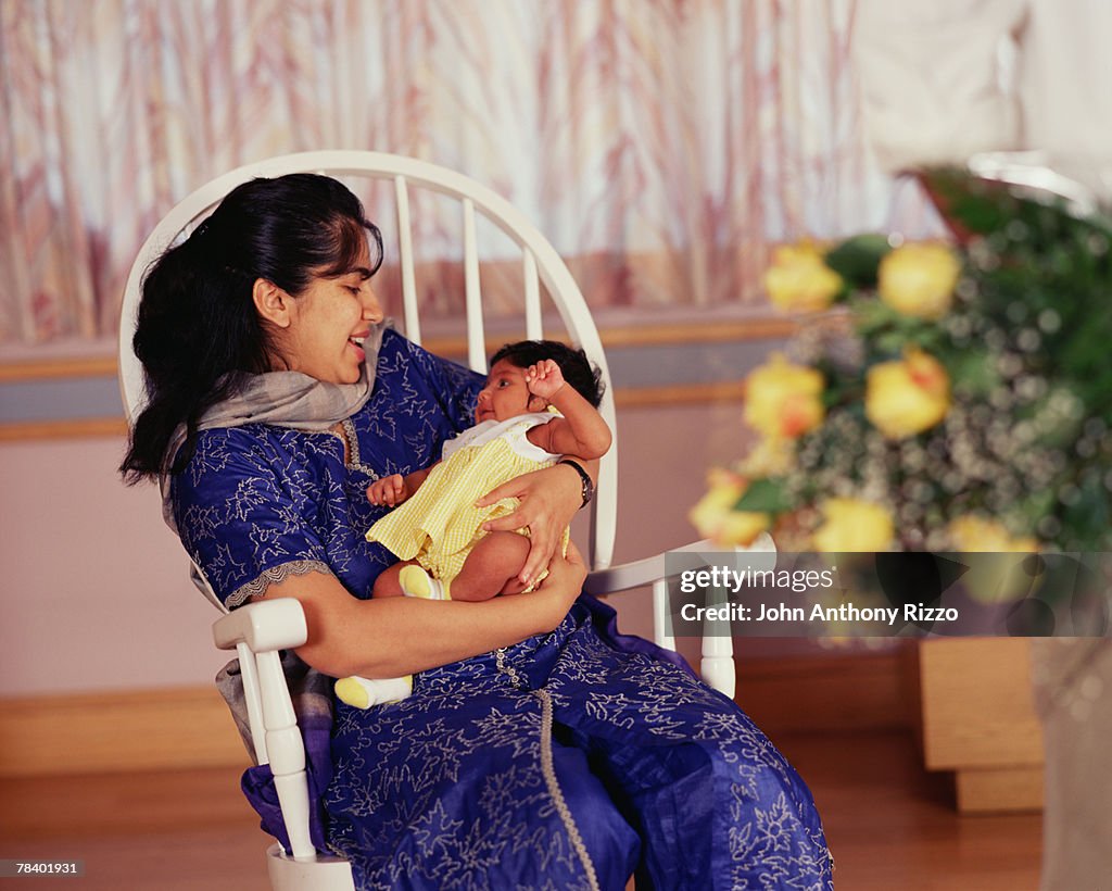 Smiling mother with newborn baby