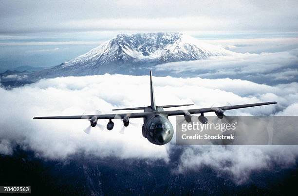 military aircraft above the clouds - c 130 hercules stockfoto's en -beelden