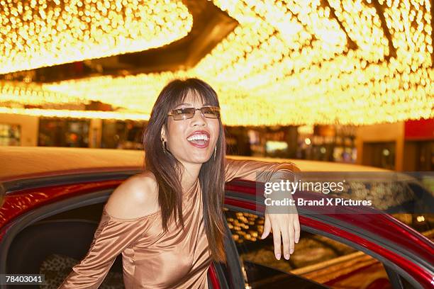 woman by limousine at casino - adult glamour stock pictures, royalty-free photos & images