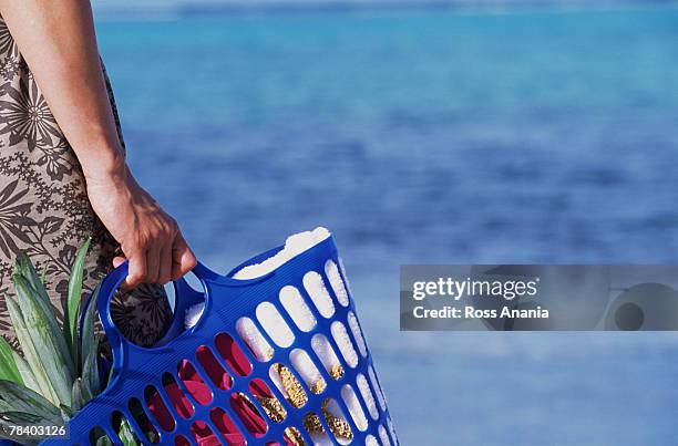 person carrying basket on beach - life si a beach stock pictures, royalty-free photos & images