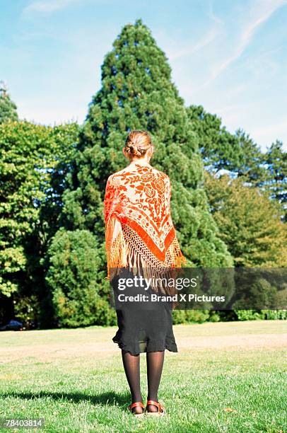 woman with a shawl by a tree - shawl stock pictures, royalty-free photos & images
