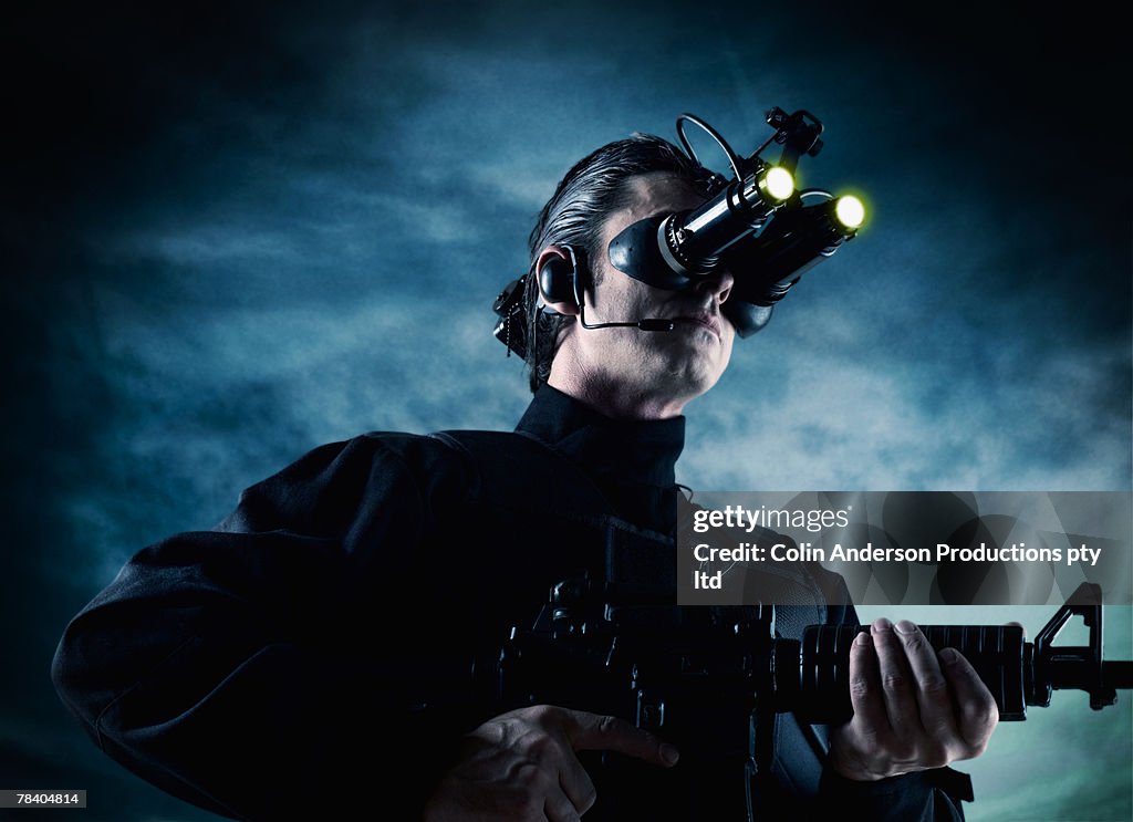 Man with night vision goggles and gun