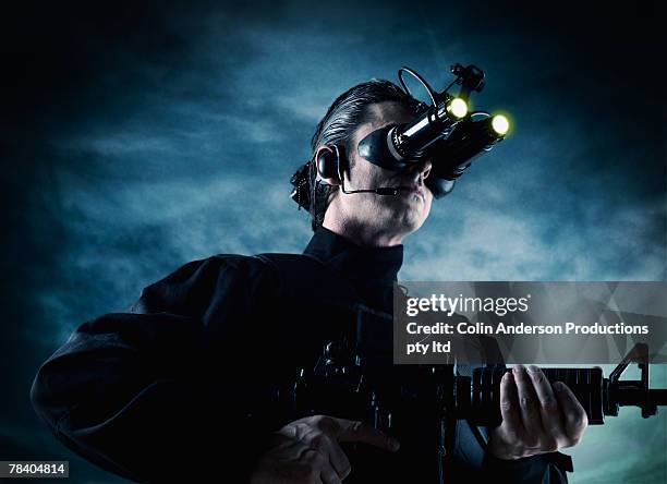 man with night vision goggles and gun - machinery guarding stock pictures, royalty-free photos & images