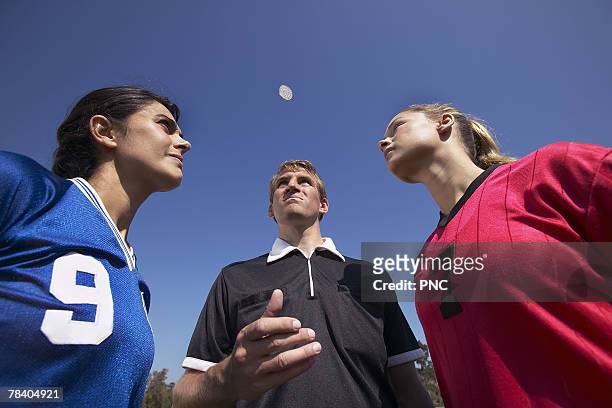 referee flipping coin - flipping a coin stock pictures, royalty-free photos & images