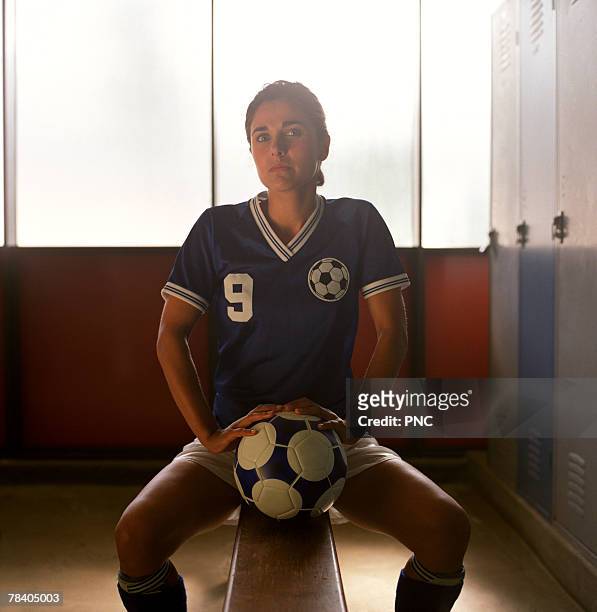 soccer player in locker room - sports equipment locker stock pictures, royalty-free photos & images