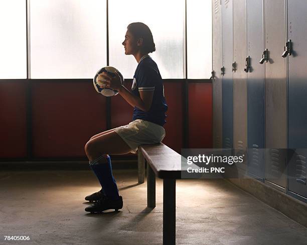 soccer player in locker room preparing for game - locker room ストックフォトと画像