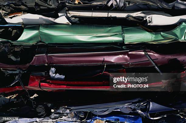 crushed cars in compactor - pressmaschine stock-fotos und bilder