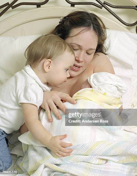 mother and children - home birth stock-fotos und bilder