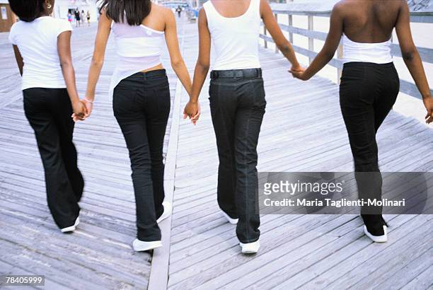 women walking on boardwalk - life si a beach stock pictures, royalty-free photos & images