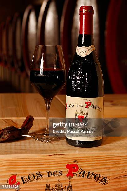 Bottle and glass of wine are displayed in the cellar of prize-winning French winegrower Paul-Vincent Avril on December 12, 2007 in...