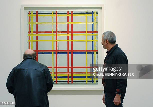 Two men inspect the painting "New York City 1 " by Dutch artist Piet Mondrian shown in the exhibition "Piet Mondrian - Vom Abbild zum Bild" 12...
