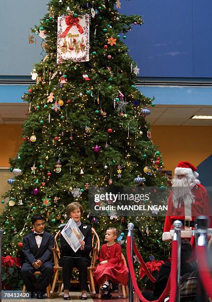 First Lady Laura Bush reads a story about "Rudolf the Red Nose Reindeer" during a visit to the Children?s National Medical Center 12 December 2007 in...