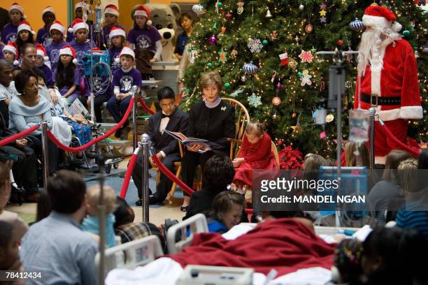 First Lady Laura Bush reads a story about "Rudolf the Red Nose Reindeer" during a visit to the Children?s National Medical Center 12 December 2007 in...