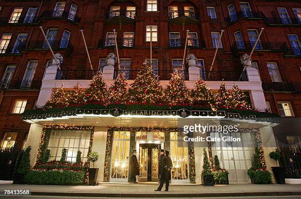 Doormen stand on duty in front of Claridges Hotel which is lit up for Christmas on December 12, 2007 in London.