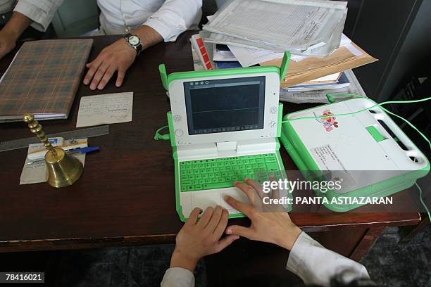 The son of Marcelo Galain, director of Primary School of Villa Cardal, 80km from Montevideo, uses one of the new laptops given to each schoolboy of...