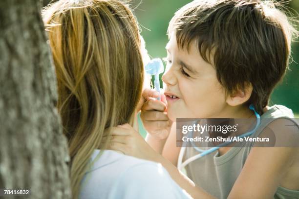 mother and son, boy pretending to be doctor - vestita da dottoressa foto e immagini stock