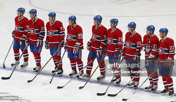 Members of the Montreal Canadiens stand for the national anthem before play against the Detroit Red Wings during their NHL game at the Bell Centre on...