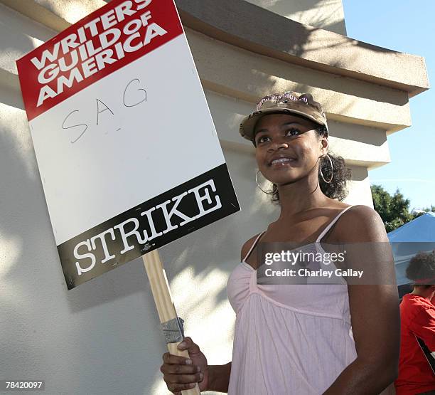 Actress Kimberly Elise poses for the press while marching to support the striking speak at the Writer's Guild of America's 'Diversity Day' at...