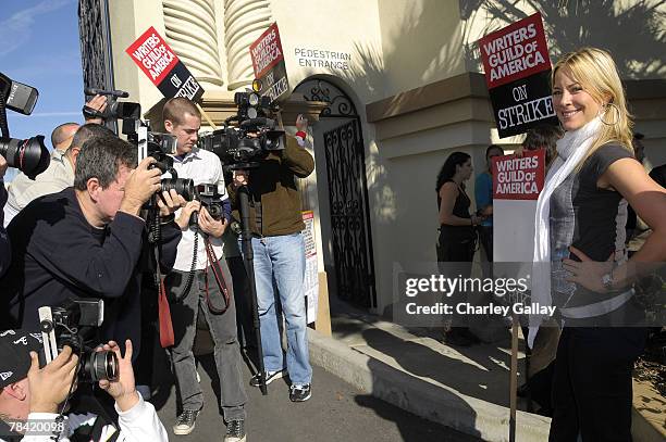 Actress Brittany Daniels poses for the press while marching to support the striking speak at the Writer's Guild of America's 'Diversity Day' at...