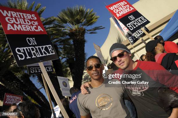 Actors Orlando Jones and Justin Chambers pose while marching to support the striking speak at the Writer's Guild of America's 'Diversity Day' at...