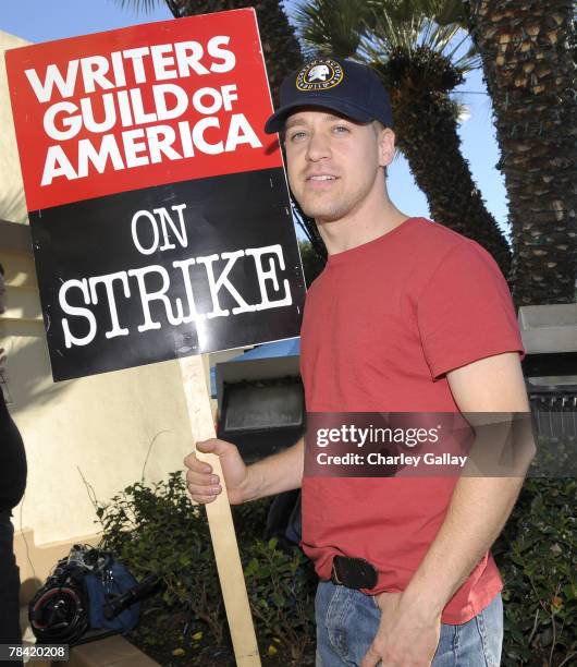 Actor T.R. Knight poses for the press while marching to support the striking speak at the Writer's Guild of America's 'Diversity Day' at Paramount...