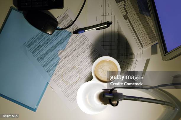 coffee mug on desk covered with paperwork - angle poise lamp stock pictures, royalty-free photos & images