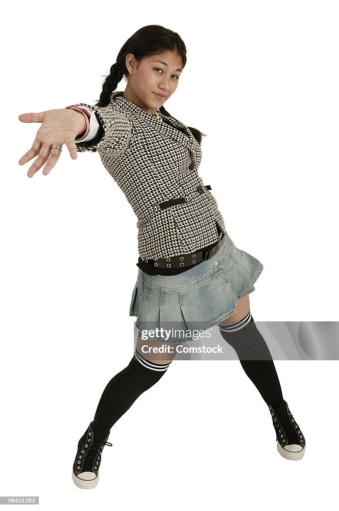 Fashionable teenage girl with hand outstretched