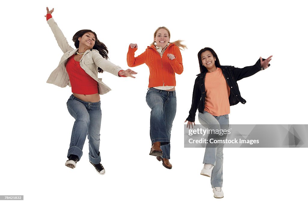 Carefree teenage girls skipping