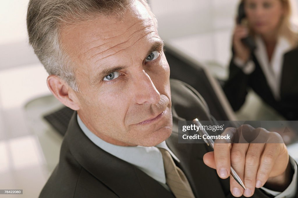 Businessman holding pen