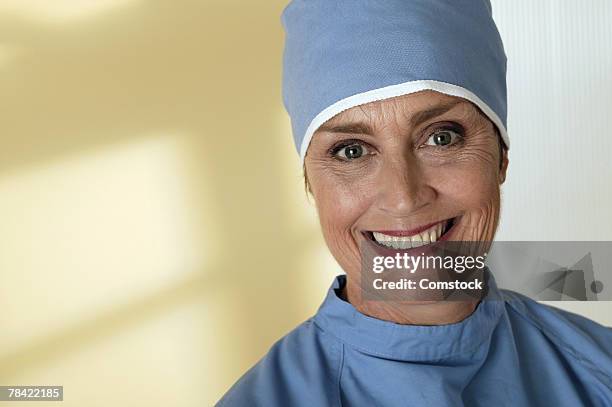 portrait of a healthcare worker in surgical scrubs - surgical cap stock pictures, royalty-free photos & images