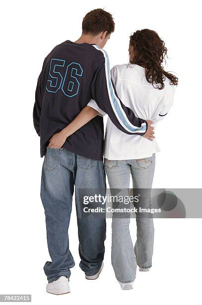 teenage boy and girl walking away together - tcs stock pictures, royalty-free photos & images