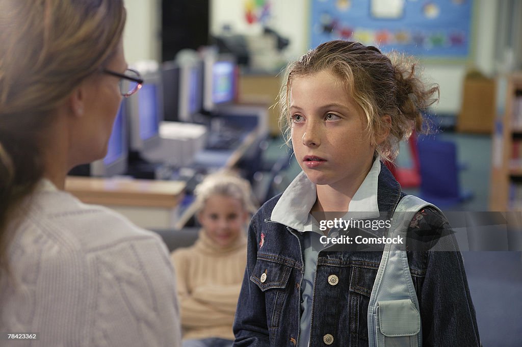 Nervous girl talking to teacher